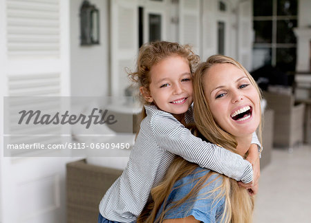 Mother and daughter playing on porch Mother and daughter playing on porch