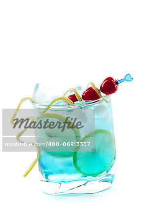 Blue alcohol cocktail with lemon and maraschino slices isolated on white background