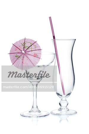 Cocktail glasses with drinking straw and umbrella. Isolated on white background