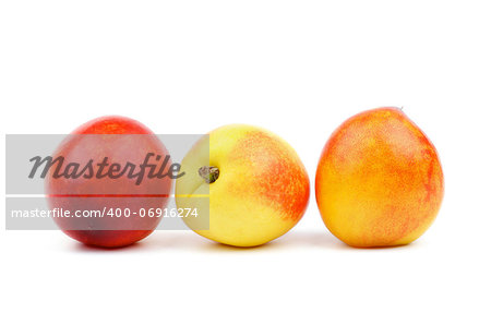 Three Nectarines In a Row isolated on white background