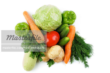 Heap of Raw Vegetables with Cabbage, Squash, Potatoes, Carrot, Green Bell Peppers, Tomato, Cucumbers, Parsley and Dill isolated on white background. Top View