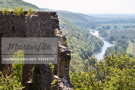 the ruins of an ancient castle stand on the hill, at the bottom of the river flows. Ukraine, Carpathians.