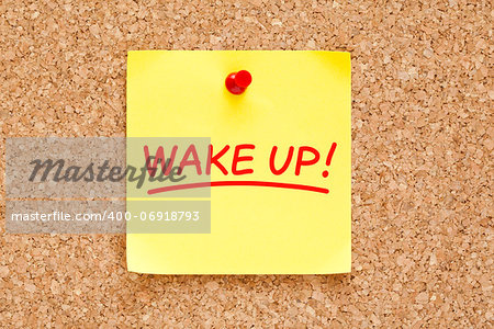 Wake Up written on yellow sticky note with red marker.