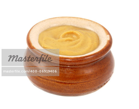 Dijon mustard served in a small ceramic pot, isolated on a white background