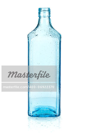 Blue empty bottle with water drops. Isolated on white background