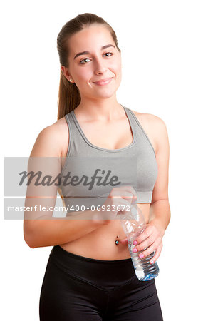 Woman holding a plastic bottle of water, dressed in sports clothes, isolated in white