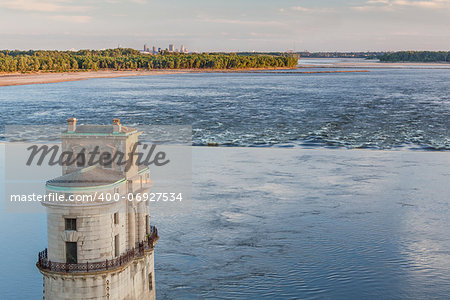 Mississippi RIver at Chain of Rocks with historical water intake tower and distant cityscape of St Louis