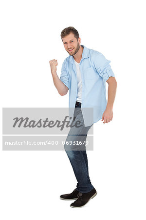 Handsome man posing with clenched fist on white background
