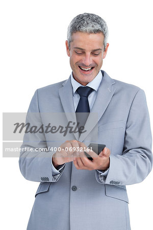 Happy businessman sending text message against white background