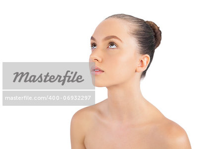 Thoughtful young brunette posing against white background