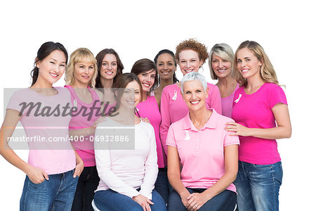 Cheerful pretty women posing and wearing pink for breast cancer on white background