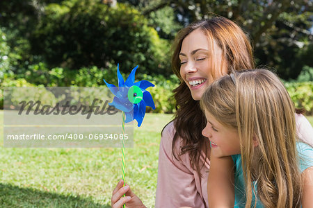 Mother with daughter with a pinwheel in the park on a sunny day