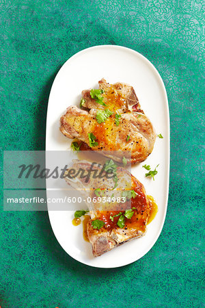 Overhead View of Pork Chops with Fruit Sauce and Cilantro, Studio Shot