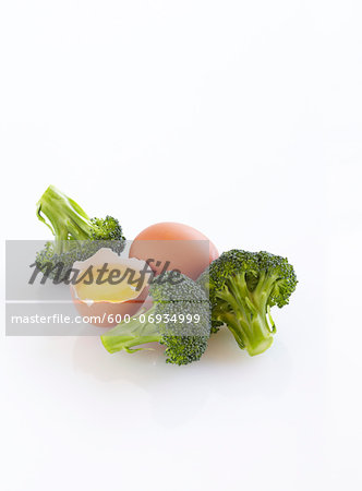 Raw Broccoli and Cracked Egg, White Background, Studio Shot