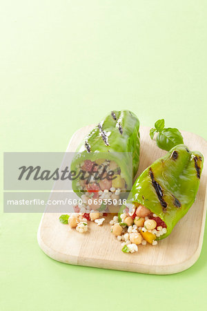 Grilled Green Peppers Stuffed with Israeli Couscous, Chickpeas and Vegetables on Cutting Board, Studio Shot