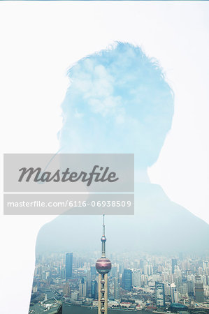 Double exposure of young businessman with headset and the skyline of Shanghai, China