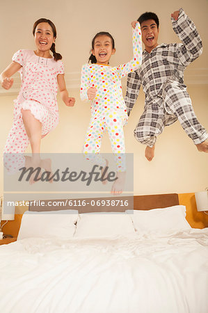 Family Jumping on Bed Together