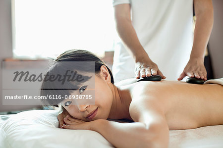 Young Woman Receiving Hot Stone Massage