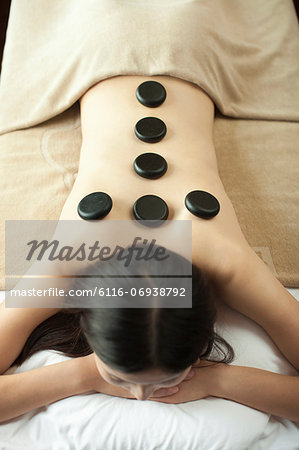 Young Woman Receiving Hot Stone Massage