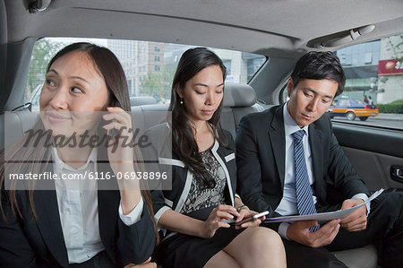 Business People Working in Car Back