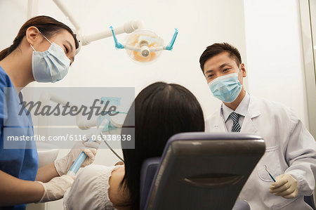 Dentists Examining Female Patient