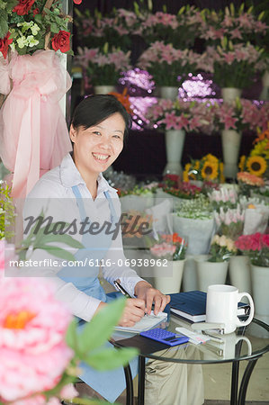 Florist Working In Flower Shop