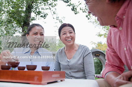 Group of mature people drinking Chinese tea in the park