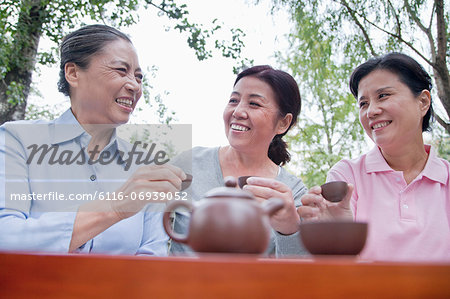 Group of mature women drinking Chinese tea in the park