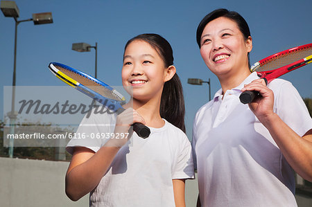 Mother and daughter playing tennis