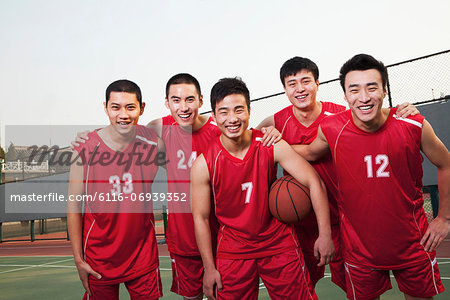 Basketball team standing and smiling, portrait