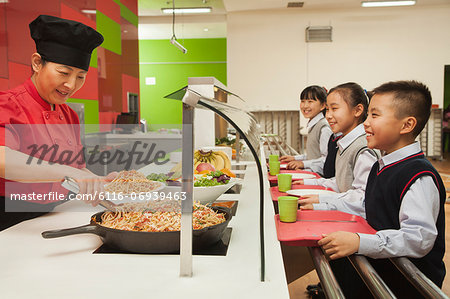 School children standing in line in school cafeteria