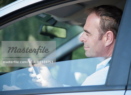 Businessman using Cell Phone while Driving, Mannheim, Baden-Wurttemberg, Germany