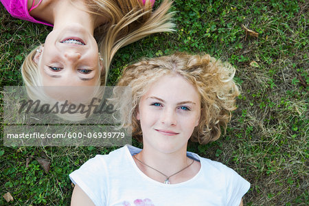 Overhead View of Teenage Girls Lying on Grass, Mannheim, Baden-Wurttemberg, Germany