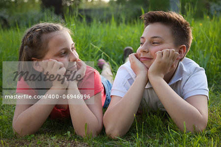 Brother and sister on a meadow in spring