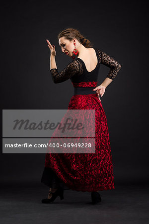 Flamenco dancer in black and red dress with red earrings
