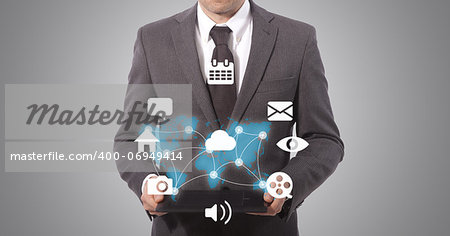 business man holding a tablet with social media connection, grey background. world map from www.lib.utexas.edu