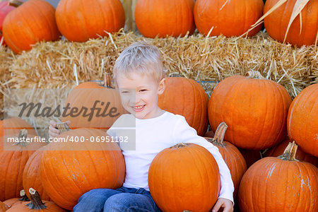 smiling cute boy at the pumpkin patch