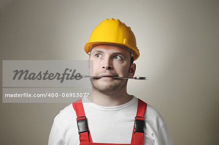 Crazy young handyman with yellow hard hat