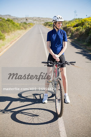 Active woman with her bike looking away