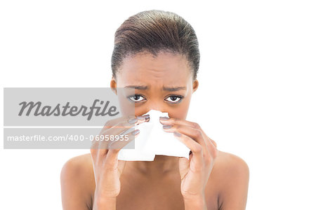 Worried natural beauty blowing her nose on white background