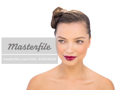 Pensive woman posing with red lips against white background