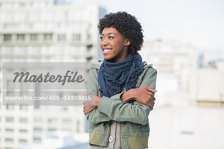 Smiling casual woman posing outdoors on a sunny day