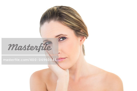 Upset woman looking at camera with a toothache against white background