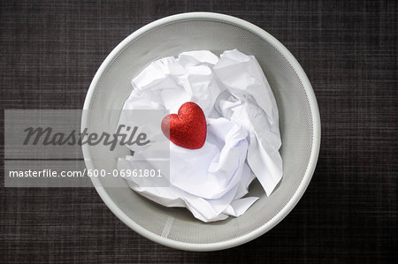 Heart shaped decoration with cruled paper in wastebasket