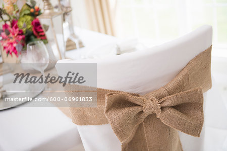 Covered chair with sash and table setting for fine dining