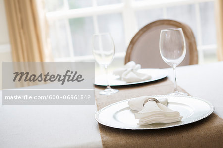 Simple and elegant place setting for two with plate charger and napkin