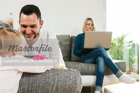 FAmily Relaxing in Living Room, Mannheim, Baden-Wurttemberg, Germany