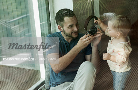 Baby Girl and Father with Headphones at Home, Mannheim, Baden-Wurttemberg, Germany