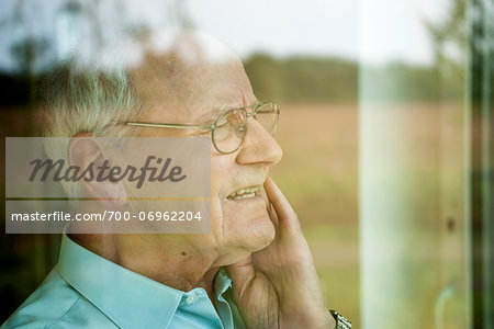 Portrait of Senior Man through Window, Mannheim, Baden-Wurttemberg, Germany