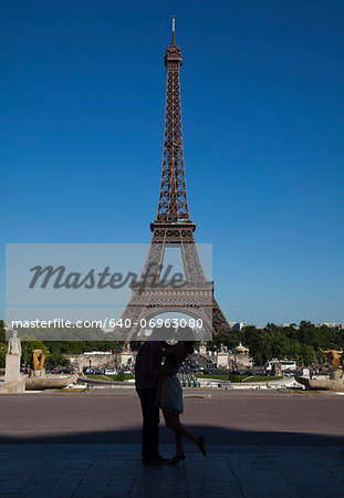 France, Couple kissing near Eiffel Tower